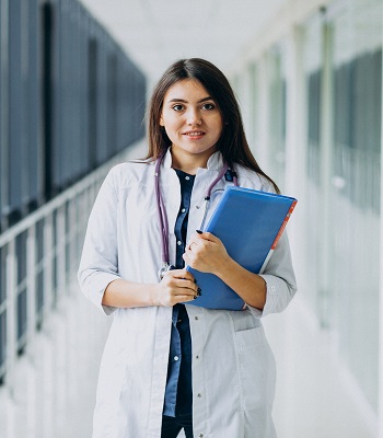 Attractive female doctor standing with documents at the hospital