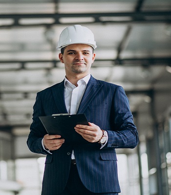 Handsome business man engineer in hard hat in a building